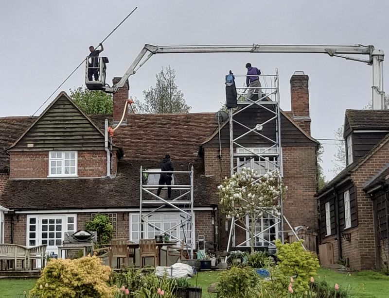 The Roof Moss Cleaners using cherry picker and scaffolding to clean roof safely and professionally in Marchwood, Hampshire